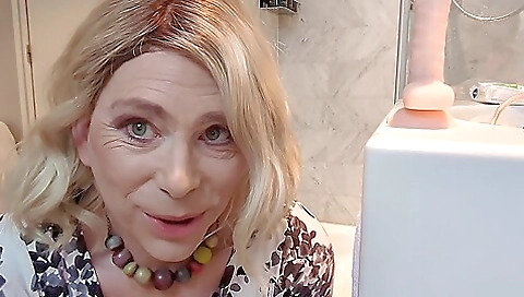 Sexy blonde milf gets on a huge dildo in her anal hole